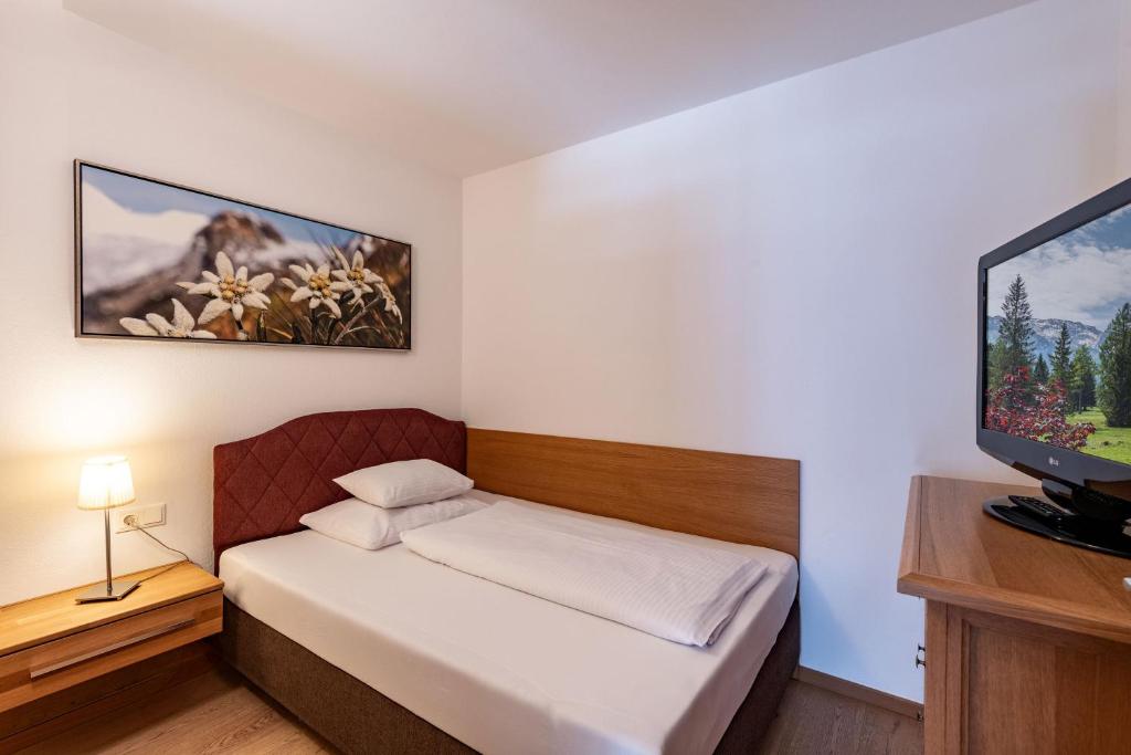 A bed or beds in a room at Alpenvital Tirol Appartements