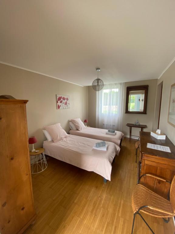 Postel nebo postele na pokoji v ubytování Le Pré Fleuri