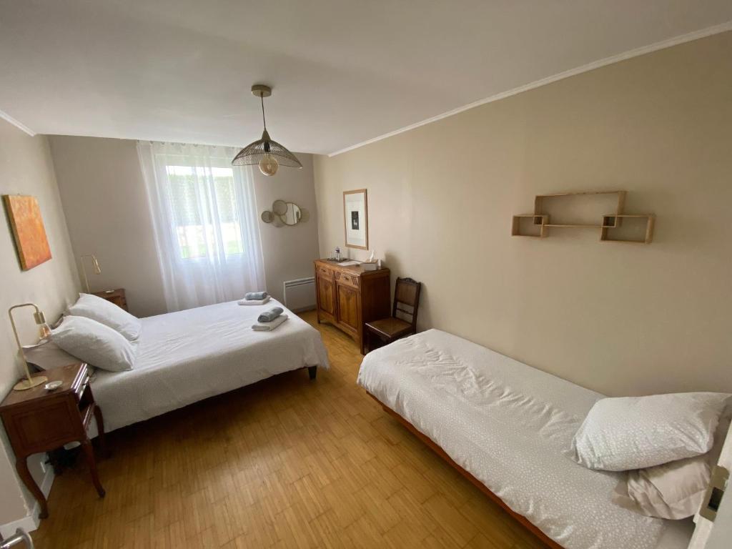 Postel nebo postele na pokoji v ubytování Le Pré Fleuri