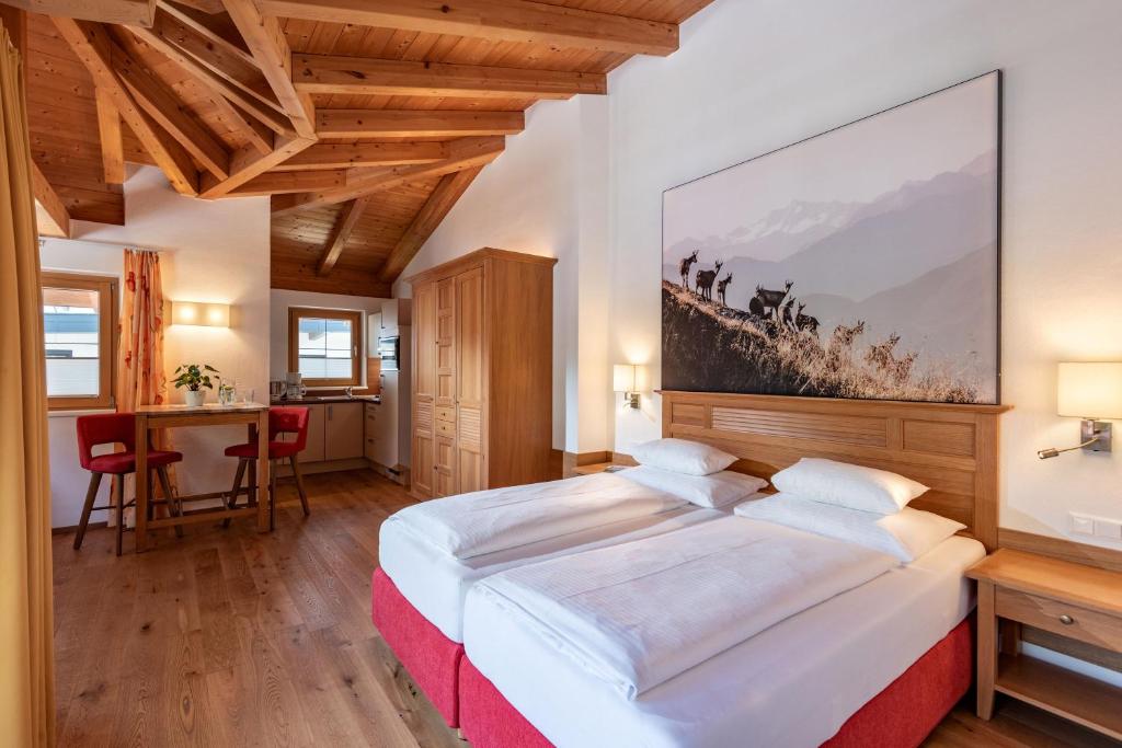 A bed or beds in a room at Alpenvital Tirol Appartements