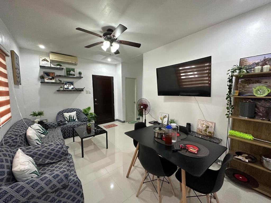 a living room with a couch and a table at Rai Staycation in Sampong