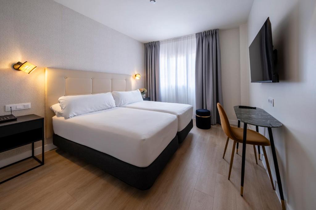 Postel nebo postele na pokoji v ubytování Hotel Cisneros
