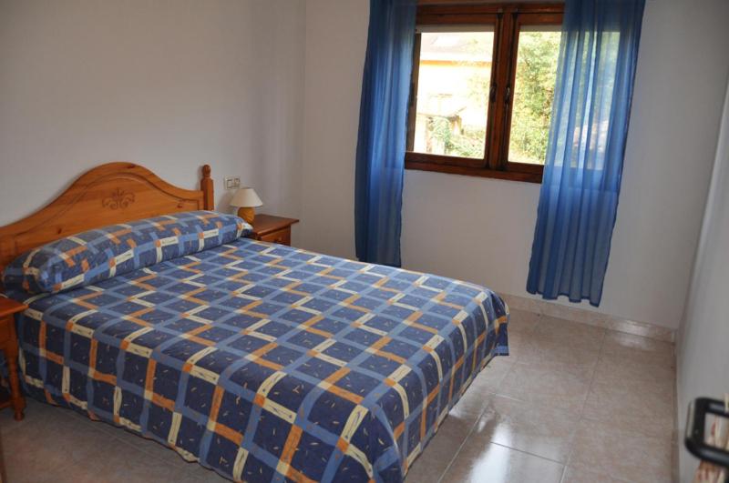 En eller flere senge i et værelse på Apartamentos La Venta