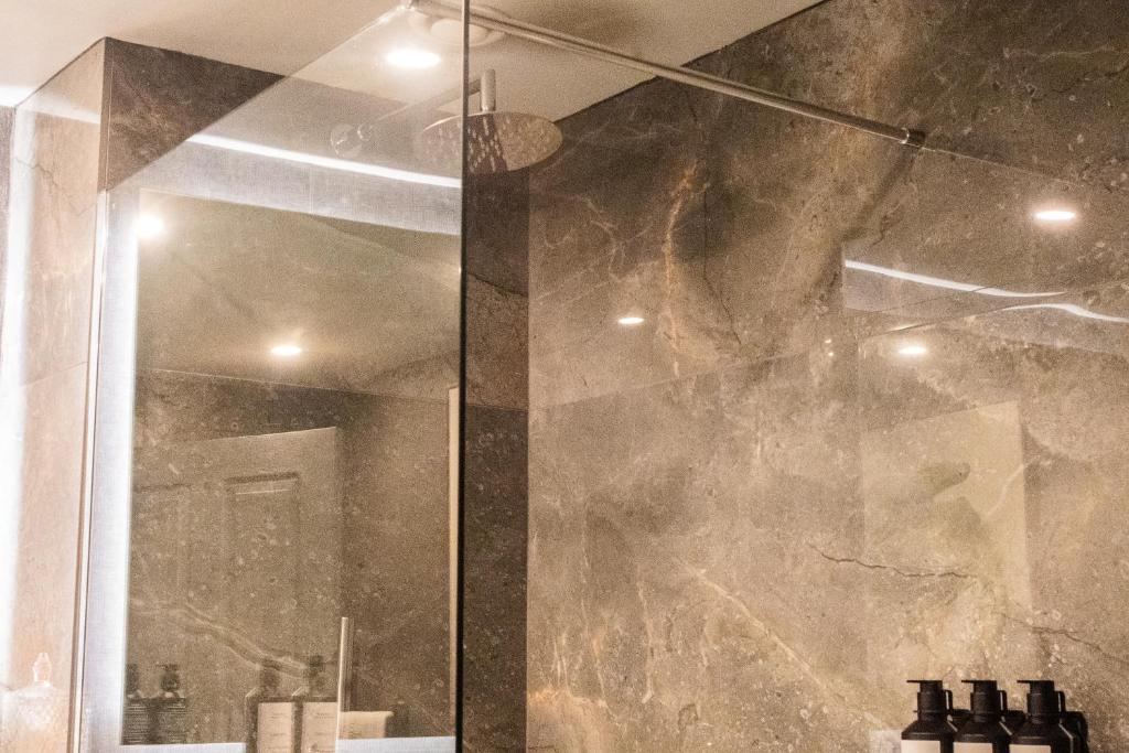 a shower with a glass door in a bathroom at Killarney Randles Hotel in Killarney