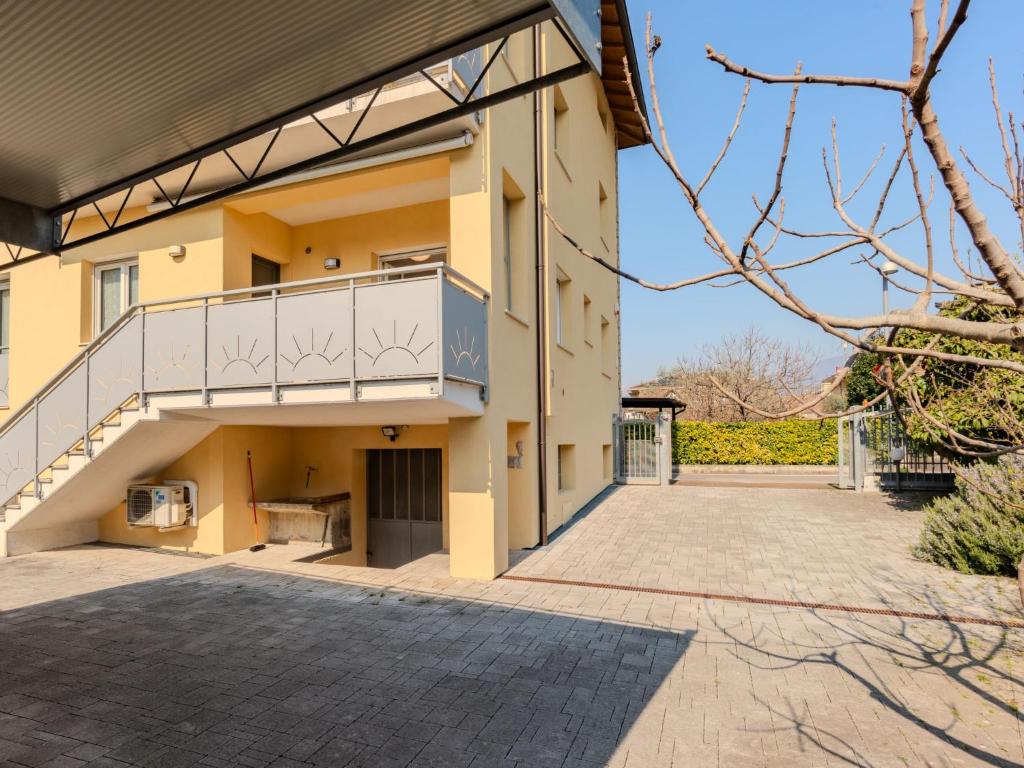a house with a balcony and a driveway at Apartment Nespolo by Interhome in Dro