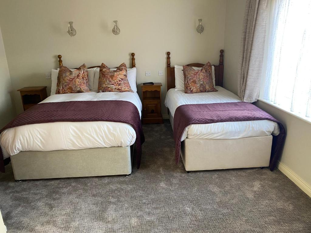 Postel nebo postele na pokoji v ubytování Ros Villa Guesthouse