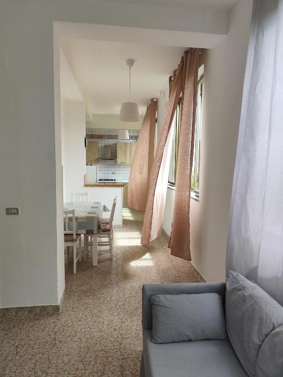 a living room with a couch and a table at Appartamenti vistAmare - La casa del vento in Vibonati