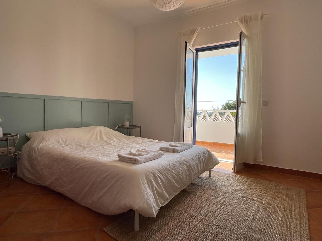 a bedroom with a bed with towels on it at Casa Manel in Odemira