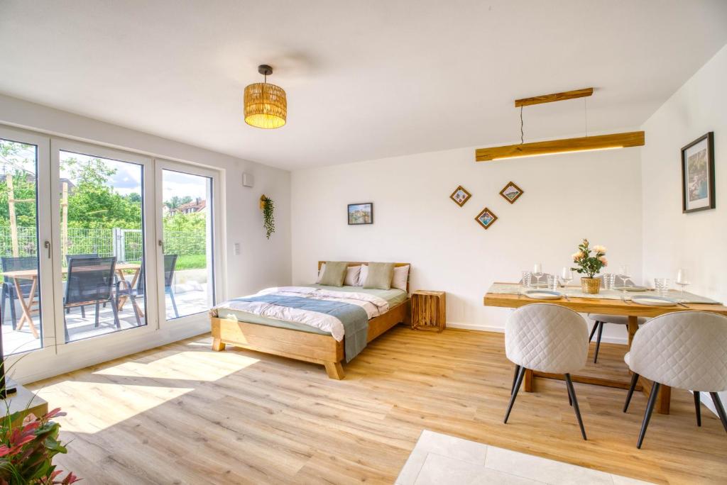 a bedroom with a bed and a table and chairs at Garten, Küche, Parkplatz & Mehr - Komfort Apartment Bavaria in Scheyern
