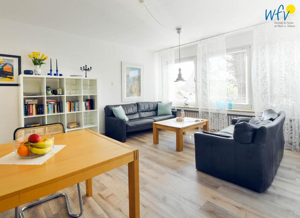 a living room with a couch and a table at Ferienhaus Caterlieschen Ferienwohnung 1 in Juist