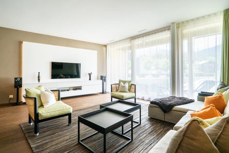 a living room with a couch and chairs and a tv at Edelweiss Mountain Suites 04-05 in Flims