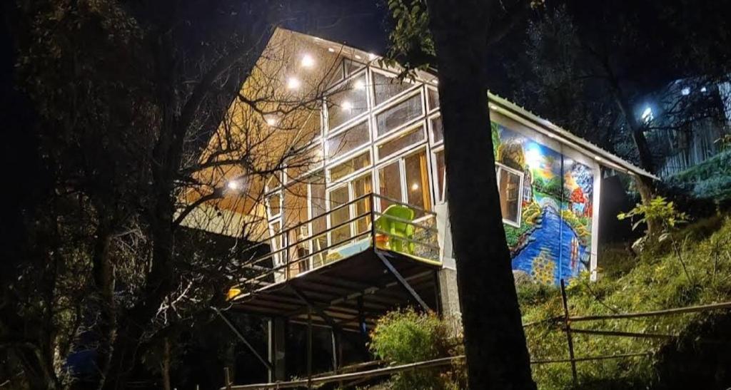 a house with a painting on the side of it at Kishkindha Resort in Joshīmath