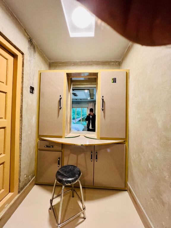 a room with a desk and a chair in it at Riverfront resort sooq valley in Dargai