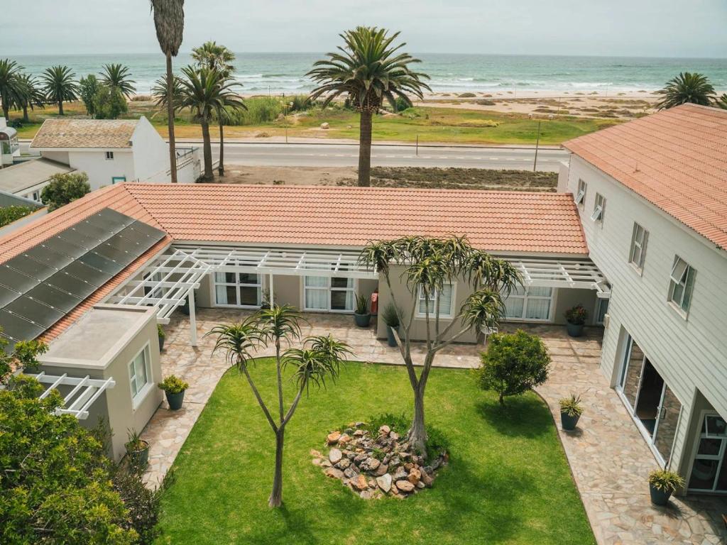 an aerial view of a house and the ocean at Ocean House Swakopmund in Swakopmund