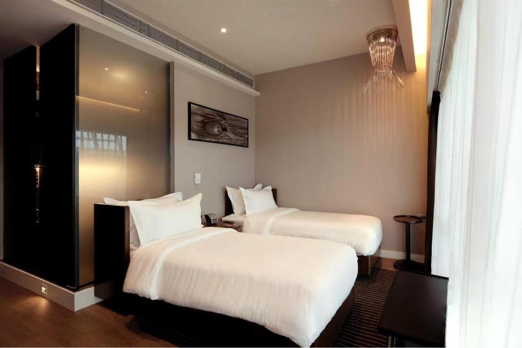 Postel nebo postele na pokoji v ubytování Hotel Grand Marina