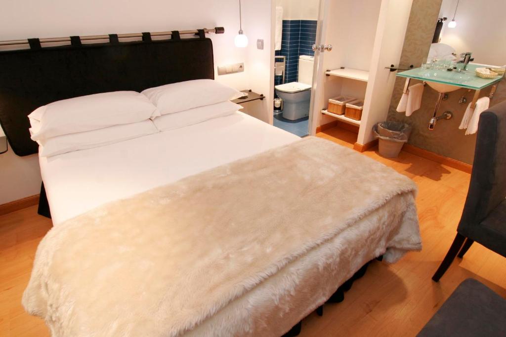 Postel nebo postele na pokoji v ubytování Hostal Santo Domingo