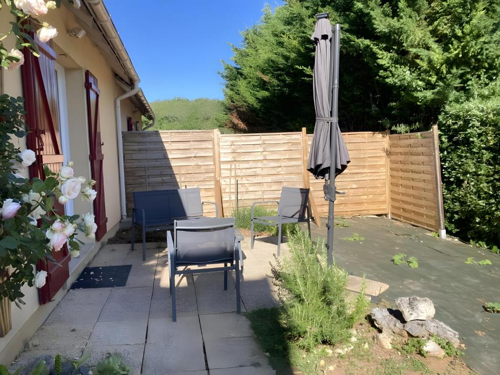 a patio with a table and an umbrella at Montagnac in Gignac