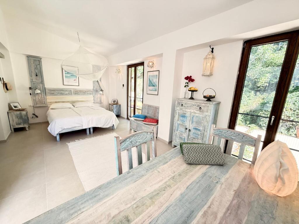 a bedroom with a bed and a table and chairs at Cefalù Forest Hideout in Cefalù