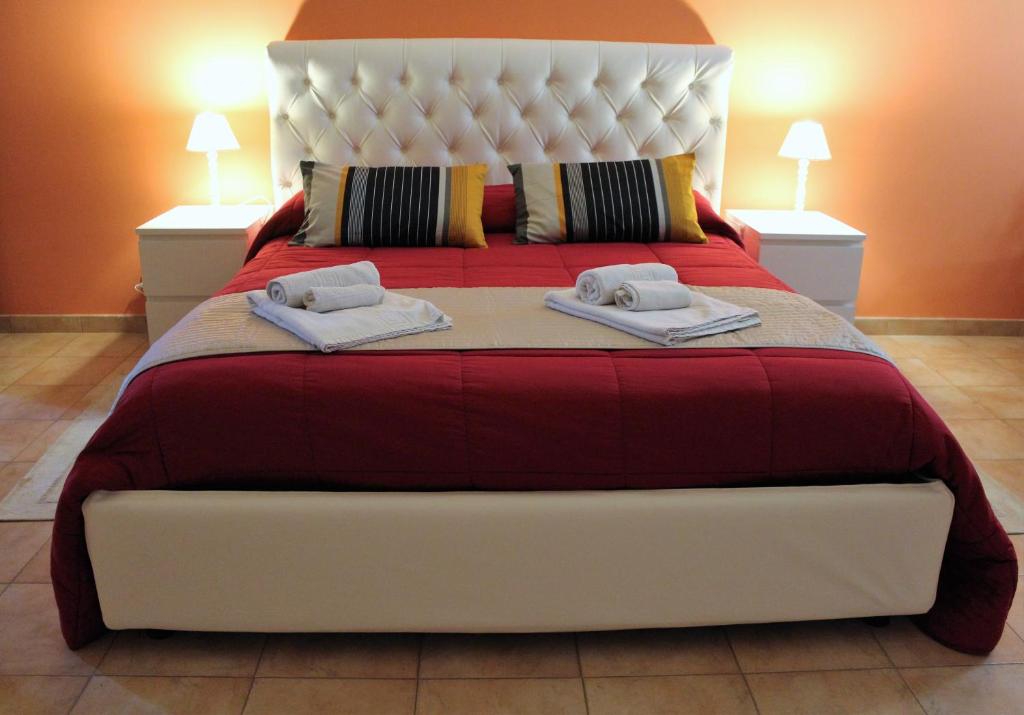 a bedroom with a large bed with two towels on it at Bed and Breakfast Dello Stretto in Villa San Giovanni