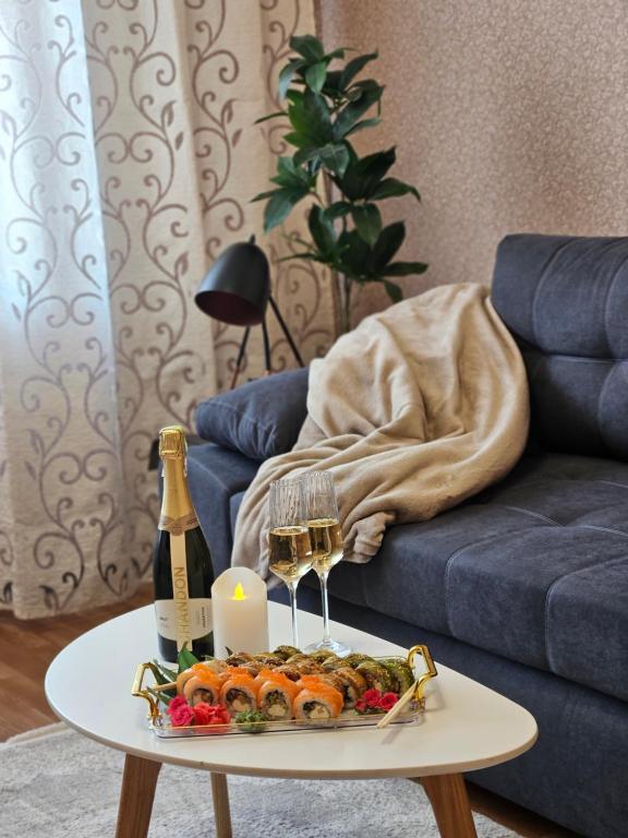 a table with a tray of food and a bottle of wine at 2к апартаменти на Космонавтів in Kryvyi Rih