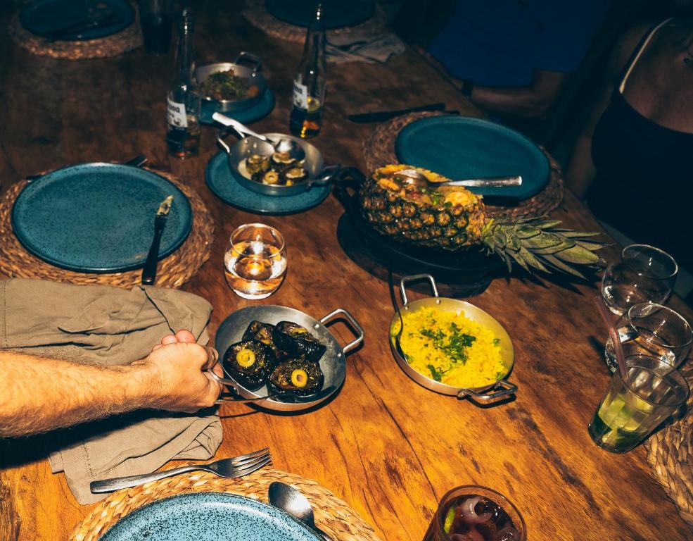 a wooden table with dishes of food on it at Tatadise in Tatajuba
