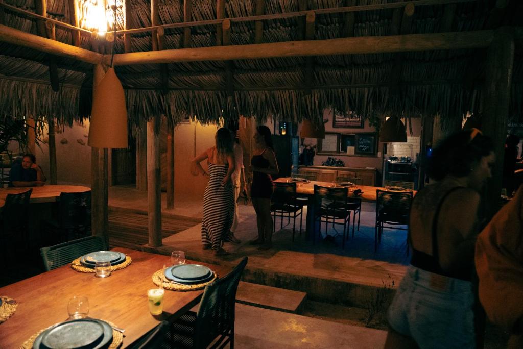two women standing in a kitchen with a table at Tatadise in Tatajuba