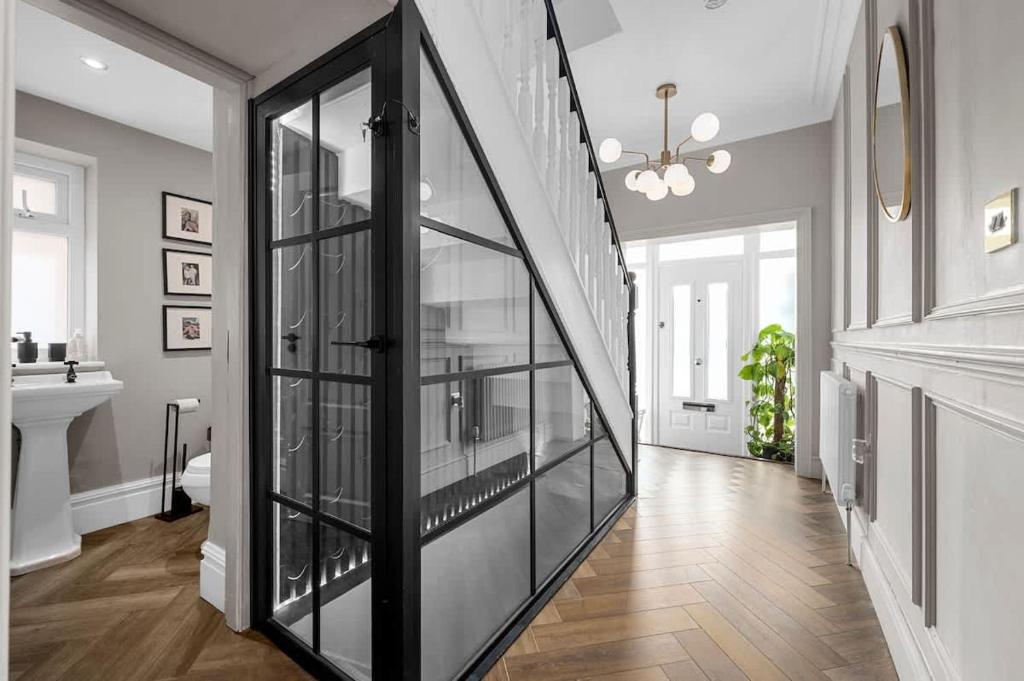 a hallway with a glass case in a house at City SuperHost Hale Family Home in Hale