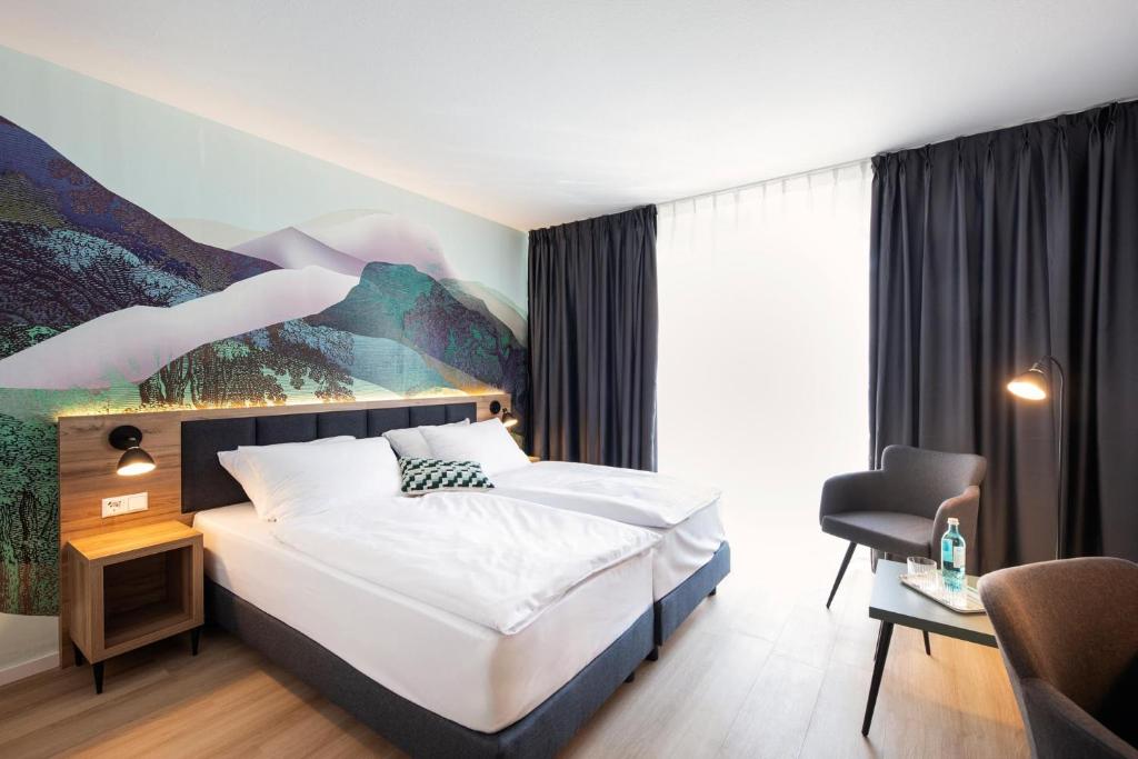 Postel nebo postele na pokoji v ubytování ACHAT Hotel Schwetzingen Heidelberg