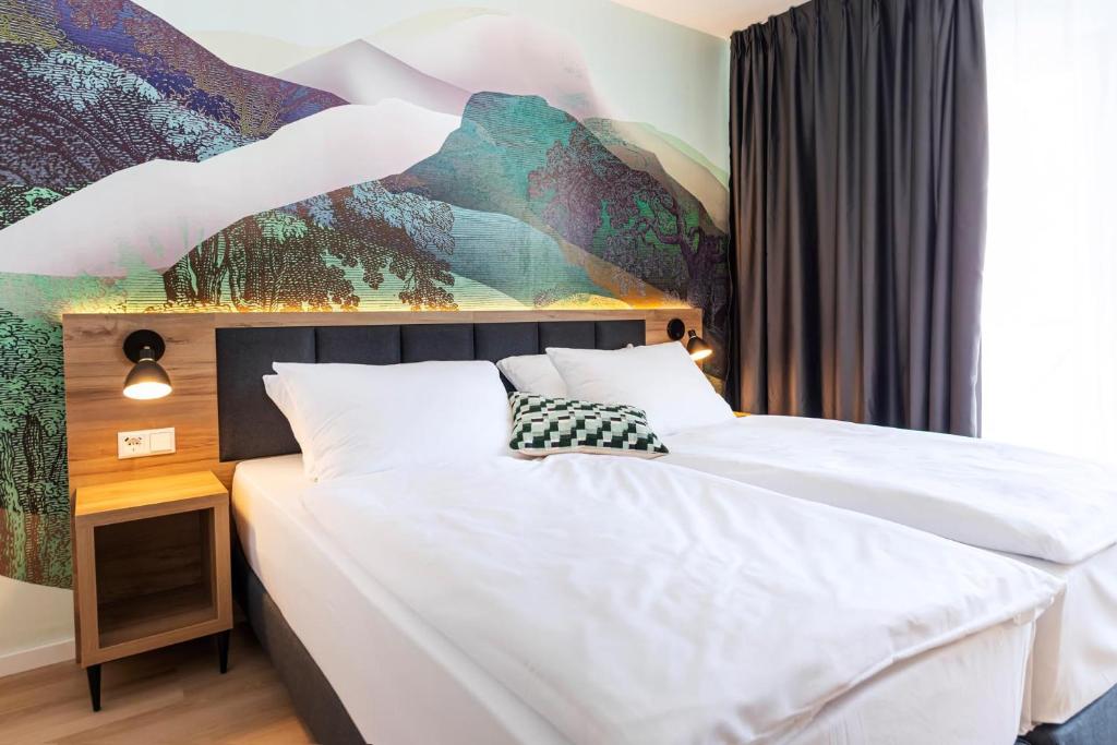 Postel nebo postele na pokoji v ubytování ACHAT Hotel Schwetzingen Heidelberg