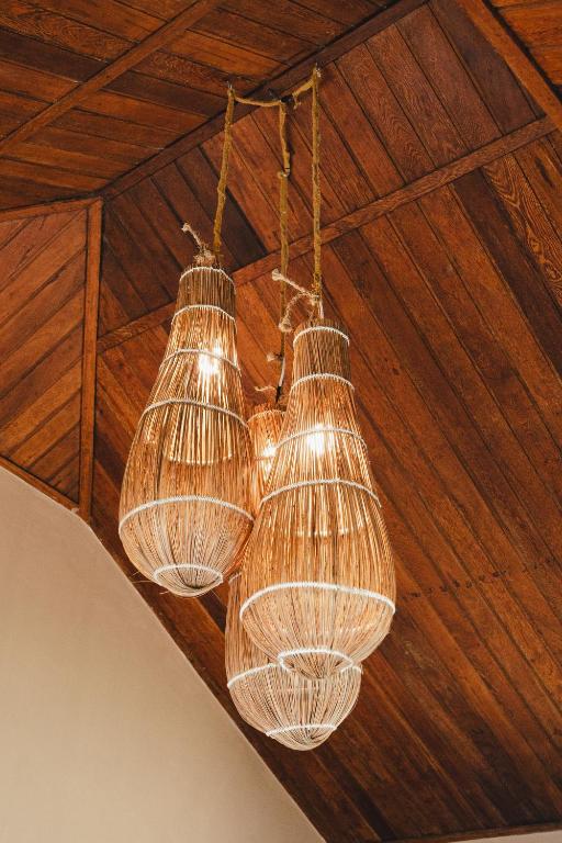 a group of glass chandeliers hanging from a ceiling at Tatadise in Tatajuba