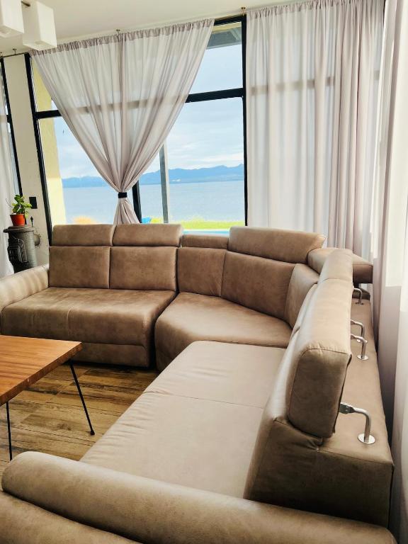 a living room with a couch and a large window at Nogal in San Carlos de Bariloche