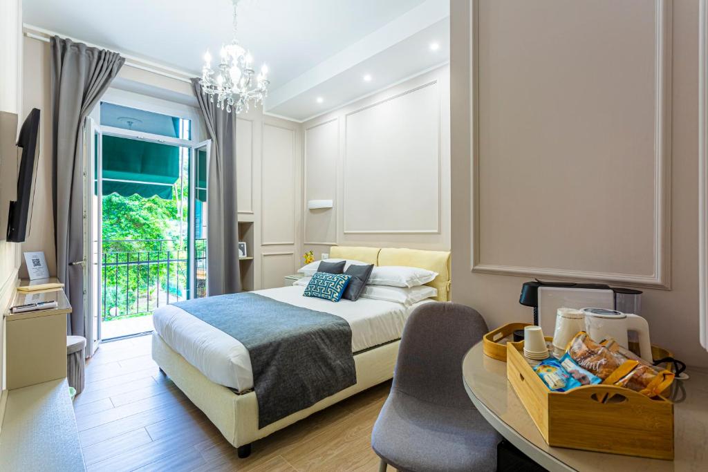 a bedroom with a bed and a table and a window at Vista Suite in Sanremo