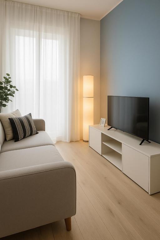 a living room with a couch and a flat screen tv at Oasi Padova Comfort - WiFi Veloce & Free Parking in Padova
