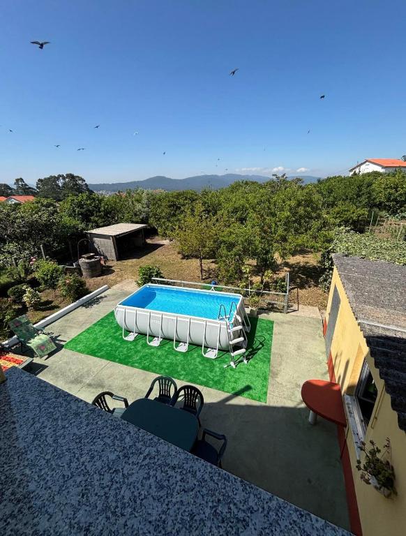 a swimming pool in the middle of a yard at Fogar do Faustino,Rianxo by Cristian&Tamara "alquileres" in Rianjo