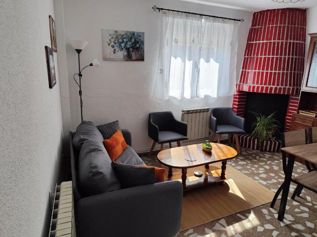 a living room with a couch and a table at VUT El Risco in Amavida