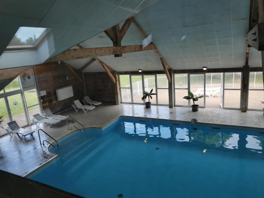a large swimming pool in a building at Les Portes d'honfleur in Boulleville