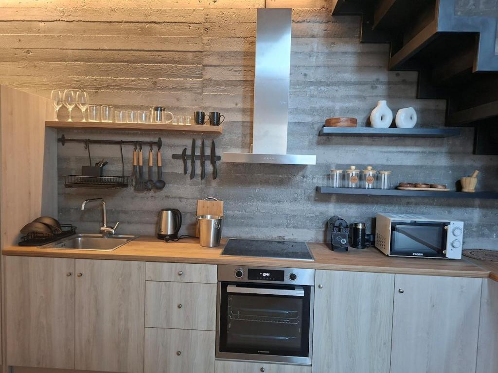 a kitchen with a sink and a stove top oven at Beautiful Plomari Cottage in Plomarion