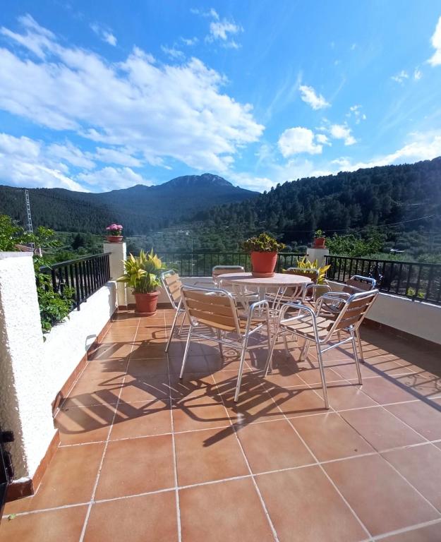 a patio with a table and chairs on a balcony at Casa Riondas in Moratalla