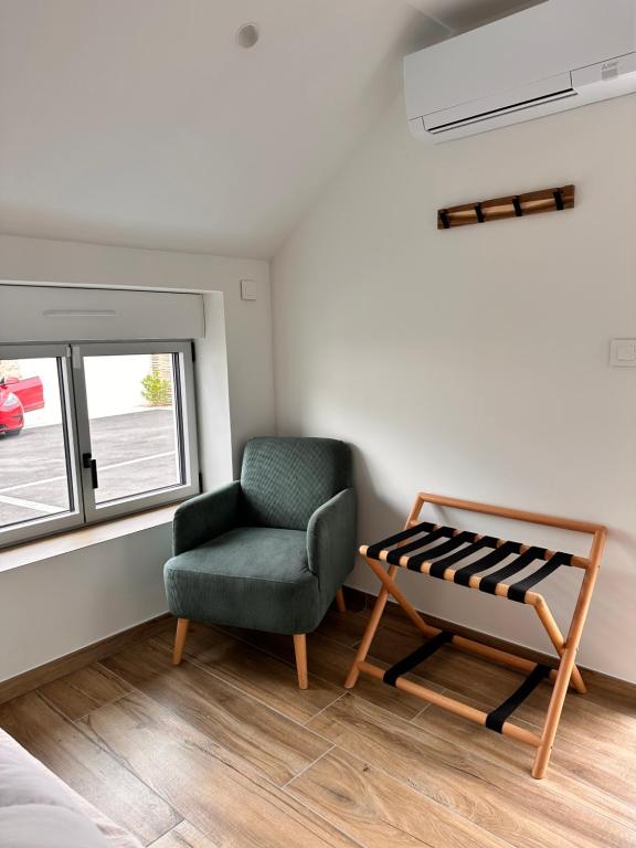 a living room with a chair and a window at Le Clos de la Côte Sauvage in Piriac-sur-Mer