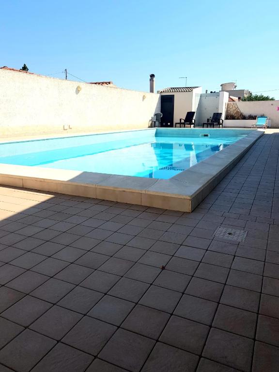 a swimming pool on the side of a building at House Rita Marzamemi in Marzamemi