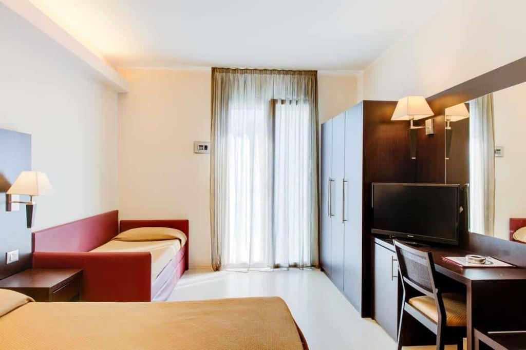 Postel nebo postele na pokoji v ubytování Hotel Capitol