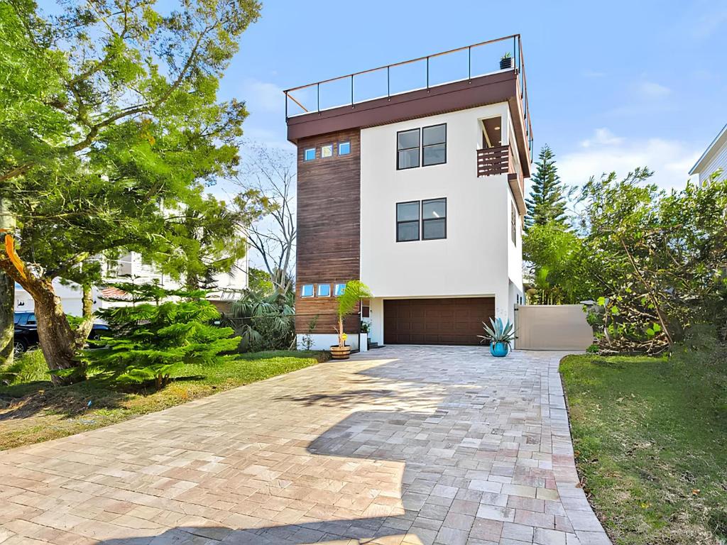 a large white house with a driveway at Anastasia Island Villa Upper Level plus Rooftop in St. Augustine