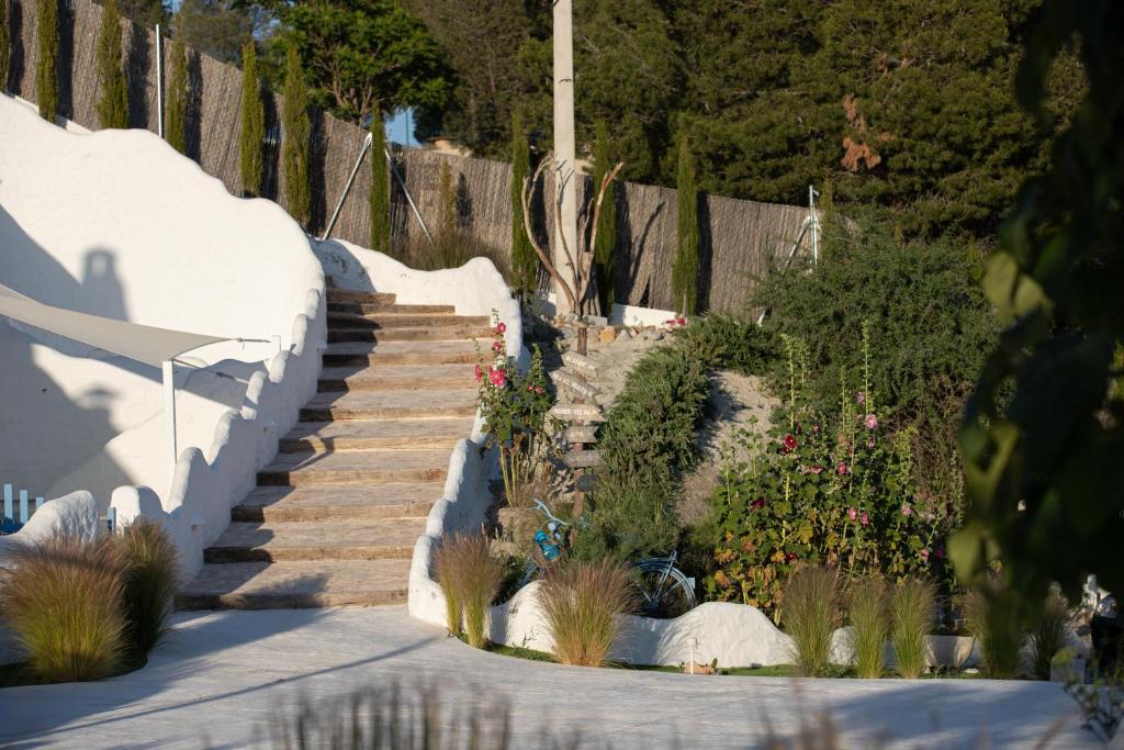 a set of stairs in a garden with flowers at Complejo Cuevas Otto in Baza