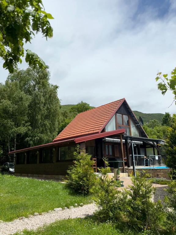 a large house with a red roof at Holiday House Vale Verde in Korenica