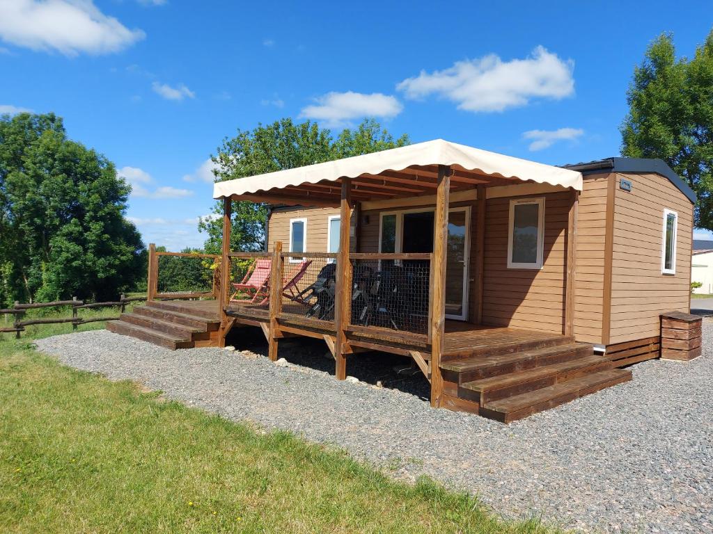 a wooden cabin with a porch and a deck at Les Lodges de l'Aubertière in La Chapelle-Saint-Étienne