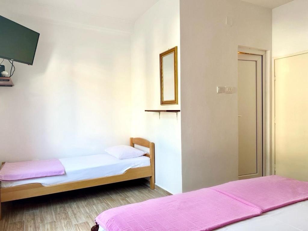 Postel nebo postele na pokoji v ubytování Apartmani i sobe Radojičić