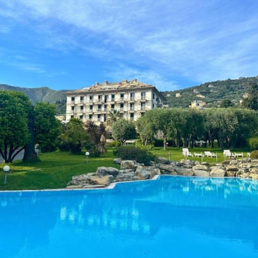 a large pool of blue water in front of a building at Nervi, sea view in Genoa