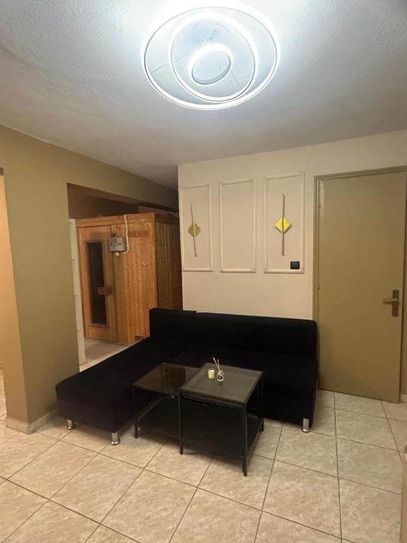 a living room with a black couch and a table at Your private villa in Ptolemaida