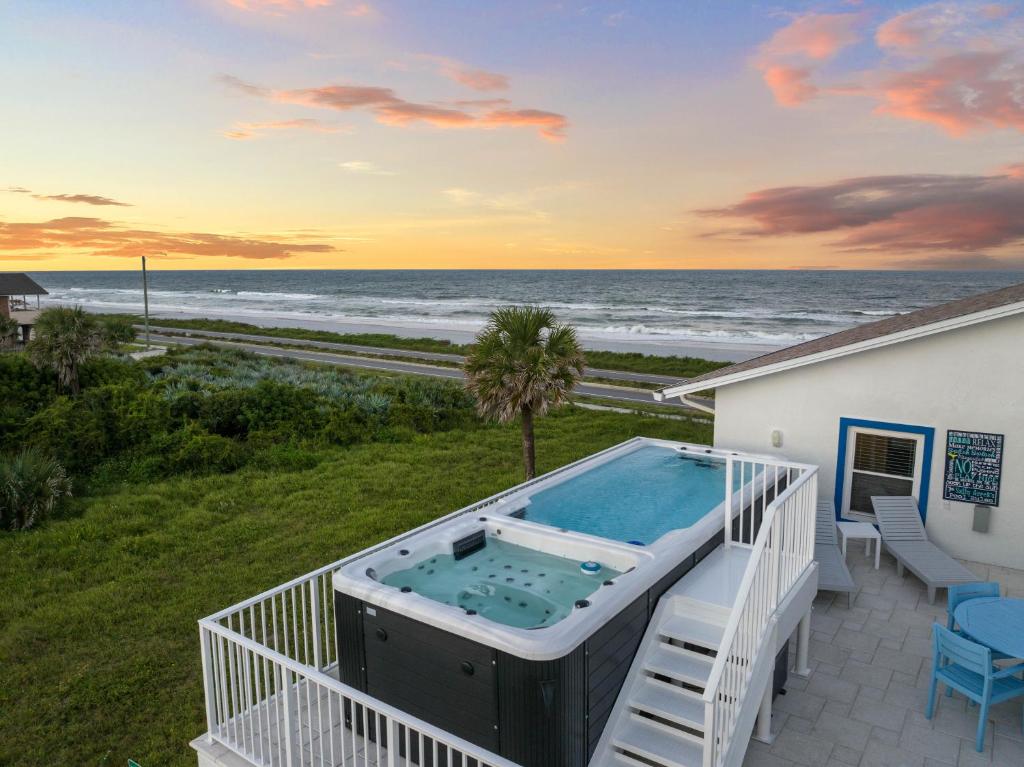a view of the ocean from a balcony with a hot tub at Salty Greek in Flagler Beach