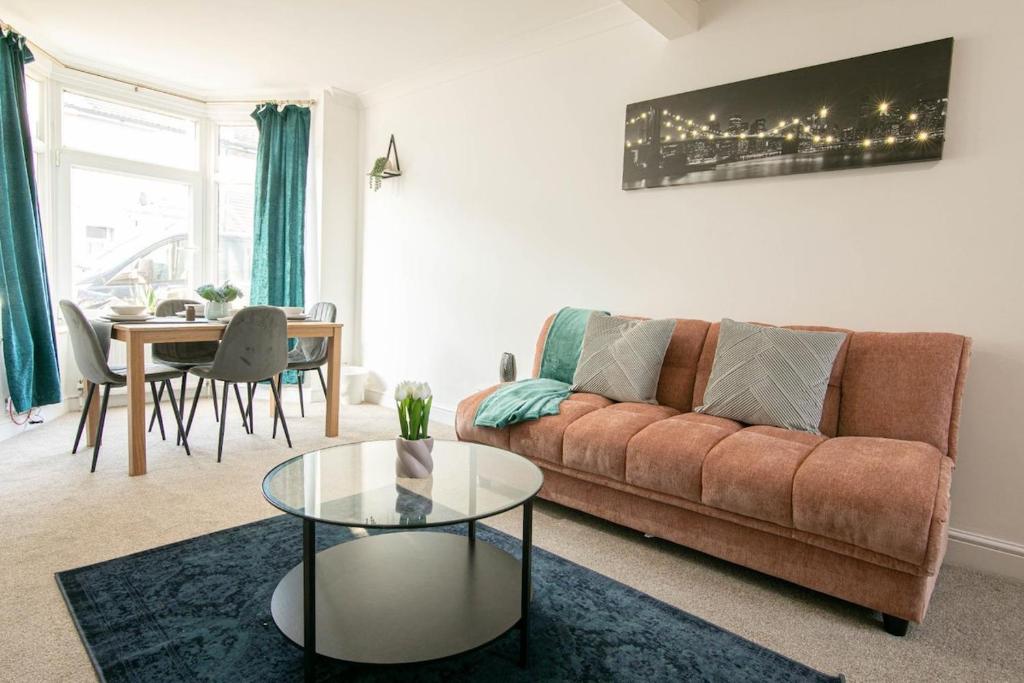 a living room with a couch and a table at 3 bed Modern Home, Vibrant & Stylish, Sleep upto 7 in Portsmouth
